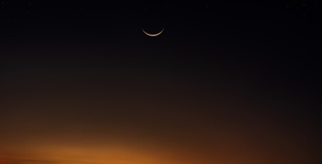 Wall Mural - crescent moon on dusk sky twilight after sundown well free space for text ramadan kareem, eid al fit