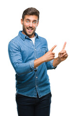 Poster - Young handsome man over isolated background smiling and looking at the camera pointing with two hands and fingers to the side.