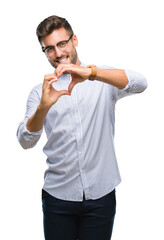 Young handsome man over isolated background smiling in love showing heart symbol and shape with hands. Romantic concept.