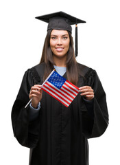 Poster - Young hispanic woman wearing graduated uniform holding flag of america with a happy face standing and smiling with a confident smile showing teeth