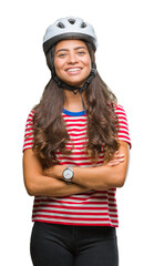 Sticker - Young arab cyclist woman wearing safety helmet over isolated background happy face smiling with crossed arms looking at the camera. Positive person.