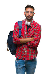 Wall Mural - Adult hispanic student man wearing headphones and backpack over isolated background skeptic and nervous, disapproving expression on face with crossed arms. Negative person.