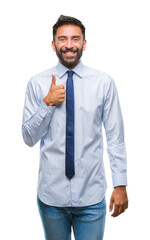 Wall Mural - Adult hispanic business man over isolated background doing happy thumbs up gesture with hand. Approving expression looking at the camera with showing success.