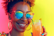 Young black girl relaxing on the disco a cocktail in a glass. Handsome girl happily drinking juice, smiling on a colorful background