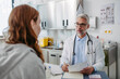© Halfpoint - Doctor discussing test results with teenage girl, explaining diagnosis and medication usage. Concept of preventive health care for adolescents.