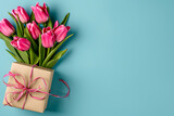 Fototapeta Tulipany - Mother's day concept - fresh beautiful tulips and present on solid color background