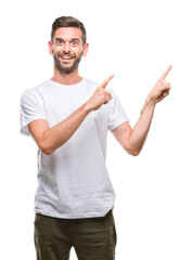 Poster - Young handsome man over isolated background smiling and looking at the camera pointing with two hands and fingers to the side.