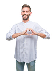 Sticker - Young handsome man over isolated background smiling in love showing heart symbol and shape with hands. Romantic concept.