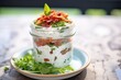 layered tzatziki dip with sundried tomatoes in glass