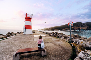 Wall Mural - White red lighthouse on the shore in Sesimbra, Portugal.