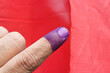 Closeup of purple indelible ink on index finger. Used in election in Malaysia to prevent fraud.