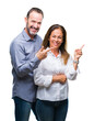 © Krakenimages.com - Middle age hispanic business couple over isolated background with a big smile on face, pointing with hand and finger to the side looking at the camera.