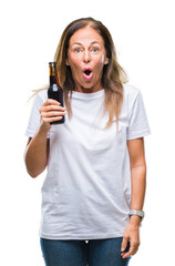 Wall Mural - Middle age hispanic woman drinking beer over isolated background scared in shock with a surprise face, afraid and excited with fear expression