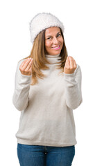 Sticker - Beautiful middle age woman wearing winter sweater and hat over isolated background Doing money gesture with hand, asking for salary payment, millionaire business