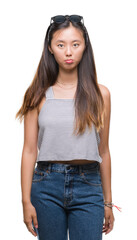 Sticker - Young asian woman wearing sunglasses over isolated background depressed and worry for distress, crying angry and afraid. Sad expression.