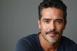 © SOLDATOOFF - Portrait of a handsome forty year old Hispanic man looking into the camera with a kind expression.