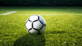 Fototapeta Sport - a soccer ball sits on the green grass and there is a white line created with Generative Ai