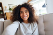 © Volodymyr - Smiling girl taking selfie picture with smartphone lying on the couch