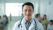 © alexkich - Smiling doctor standing in medical practice