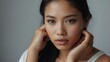 Portrait of a filipina beautiful model with natural features and touching face, treatment skin care make up ad concept from Generative AI