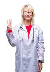 Sticker - Young beautiful blonde doctor woman wearing medical uniform over isolated background showing and pointing up with fingers number three while smiling confident and happy.