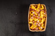 © rostyslav84 - Delicious fast food French fries with bacon and cheese sauce in a take-out cardboard box