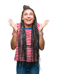 Wall Mural - Young braided hair african american girl over isolated background celebrating crazy and amazed for success with arms raised and open eyes screaming excited. Winner concept