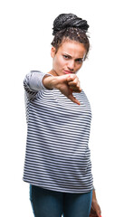 Poster - Young braided hair african american girl wearing sweater over isolated background looking unhappy and angry showing rejection and negative with thumbs down gesture. Bad expression.