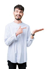 Sticker - Young handsome business man over isolated background amazed and smiling to the camera while presenting with hand and pointing with finger.