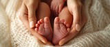Fototapeta  - newborn feet in woman's  hands, motherhood and parenting concept, family and relationships