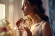 Closeup of young woman using perfume indoors