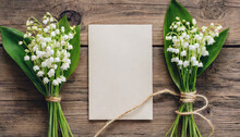 Blank Greeting Card With Spring Lily Of The Valley Flowers On Rustic Wooden Background. Wedding Invitation. Womens Day, Valentines Day Card. Mock Up. Flat Lay