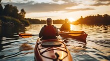 Senior Couple Kayaking On The Lake Together At Sunset