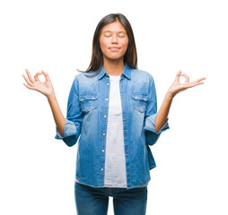 Poster - Young asian woman over isolated background relax and smiling with eyes closed doing meditation gesture with fingers. Yoga concept.