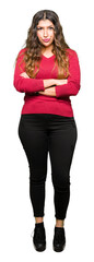 Poster - Young beautiful woman wearing red sweater skeptic and nervous, disapproving expression on face with crossed arms. Negative person.