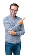 © Krakenimages.com - Handsome middle age elegant senior man wearing glasses over isolated background Pointing with hand finger to the side showing advertisement, serious and calm face