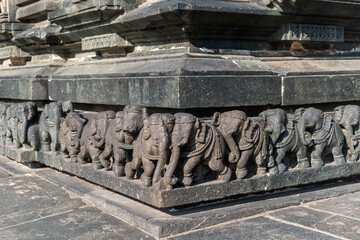 Poster - Intricate carvings of a line of elephants on the wall of the ancient Chennakashava temple in Belur in Karnataka.