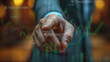 Doigt d'un homme d'affaires pointant vers un graphique de bourse affiché sur une interface virtuelle. A businessman's finger pointing at a stock market chart displayed on a virtual interface.