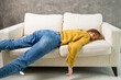 © metelevan - tired young woman sleeping on the couch, feet on the floor