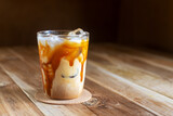 ice caramel macchiato coffee on  wooden table.