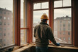 © Adri Zen - A construction worker installing new windows in an apartment. Generative AI.