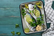 Raw fresh. Fresh raw dorado with lemon, lime, parsley and salt on old wooden blue background ready for cooking. Sea bream, dorado. Seafood, healthy food. Top view. Long banner format.
