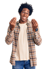 Wall Mural - handsome african american man with afro hair wearing casual clothes and glasses doing money gesture 