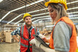 © ultramansk - Team workers carpenter wearing safety uniform and hard hat working and checking the quality of wooden products at workshop manufacturing. man and woman workers wood in dark warehouse industry.