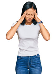 Canvas Print - Beautiful hispanic woman wearing casual white tshirt with hand on head, headache because stress. suffering migraine.