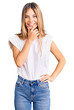© Krakenimages.com - Beautiful caucasian woman with blonde hair wearing casual white tshirt looking confident at the camera smiling with crossed arms and hand raised on chin. thinking positive.