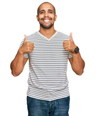 Canvas Print - Hispanic adult man wearing casual clothes success sign doing positive gesture with hand, thumbs up smiling and happy. cheerful expression and winner gesture.