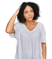 Poster - Young african american girl wearing casual clothes confuse and wonder about question. uncertain with doubt, thinking with hand on head. pensive concept.