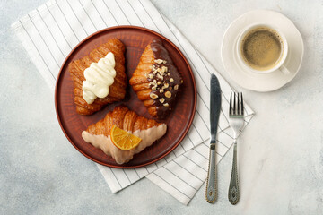 Wall Mural - Glazed croissants on clay plate on table