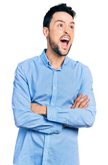 Canvas Print - Hispanic man with beard with arms crossed gesture angry and mad screaming frustrated and furious, shouting with anger looking up.